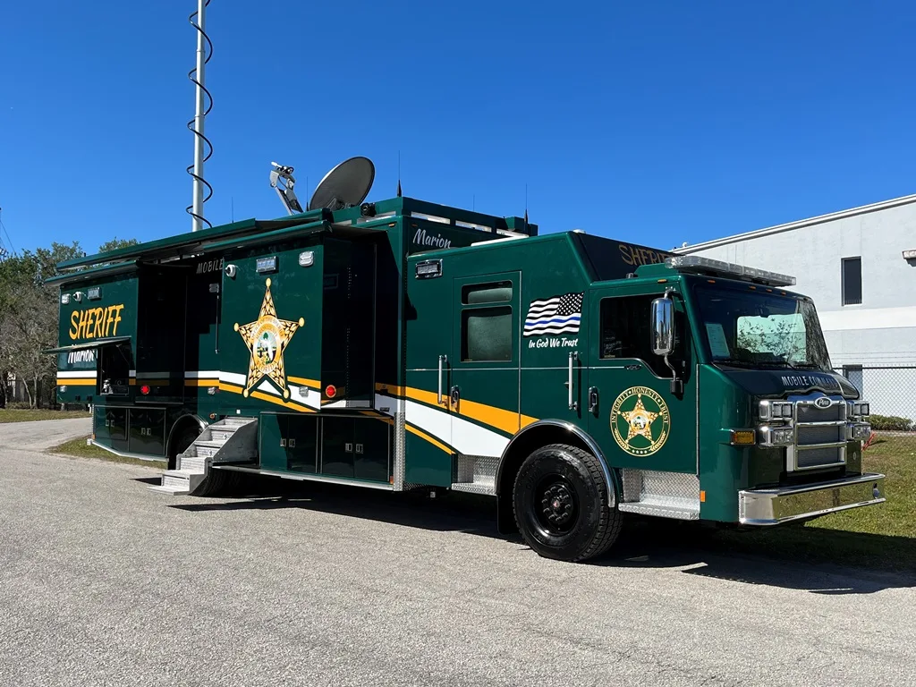 Frontline Communications C-44X-4 Large Mobile Command vehicle for Marion County Sheriff’s Office parked outside near the building on a sunny day.