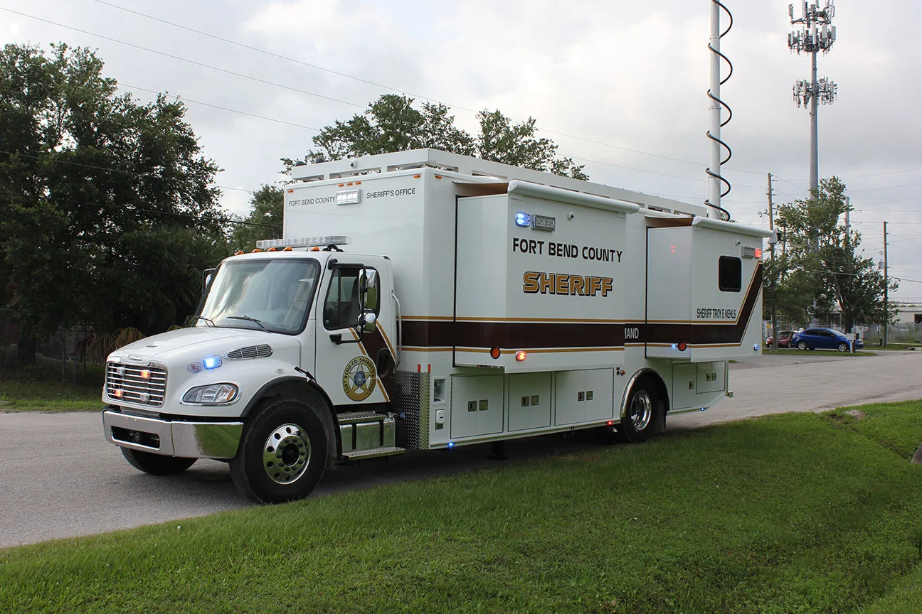 Frontline Communications C-35X-3 Mobile Command vehicle parked outside on a cloudy day.