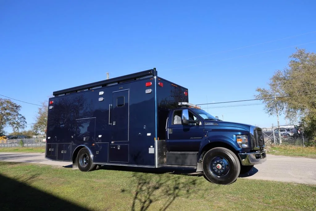 C-33X Medical Command Center parked outside near the Frontline Communications building on a sunny day.
