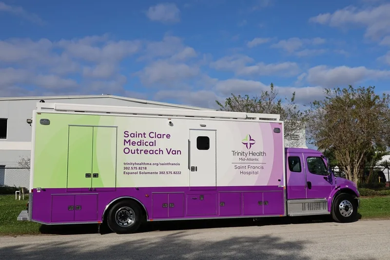 St. Francis Hospital C-38 Mobile Medical Outreach Specialty Vehicle parked outside of the Frontline Communications building on a sunny day.