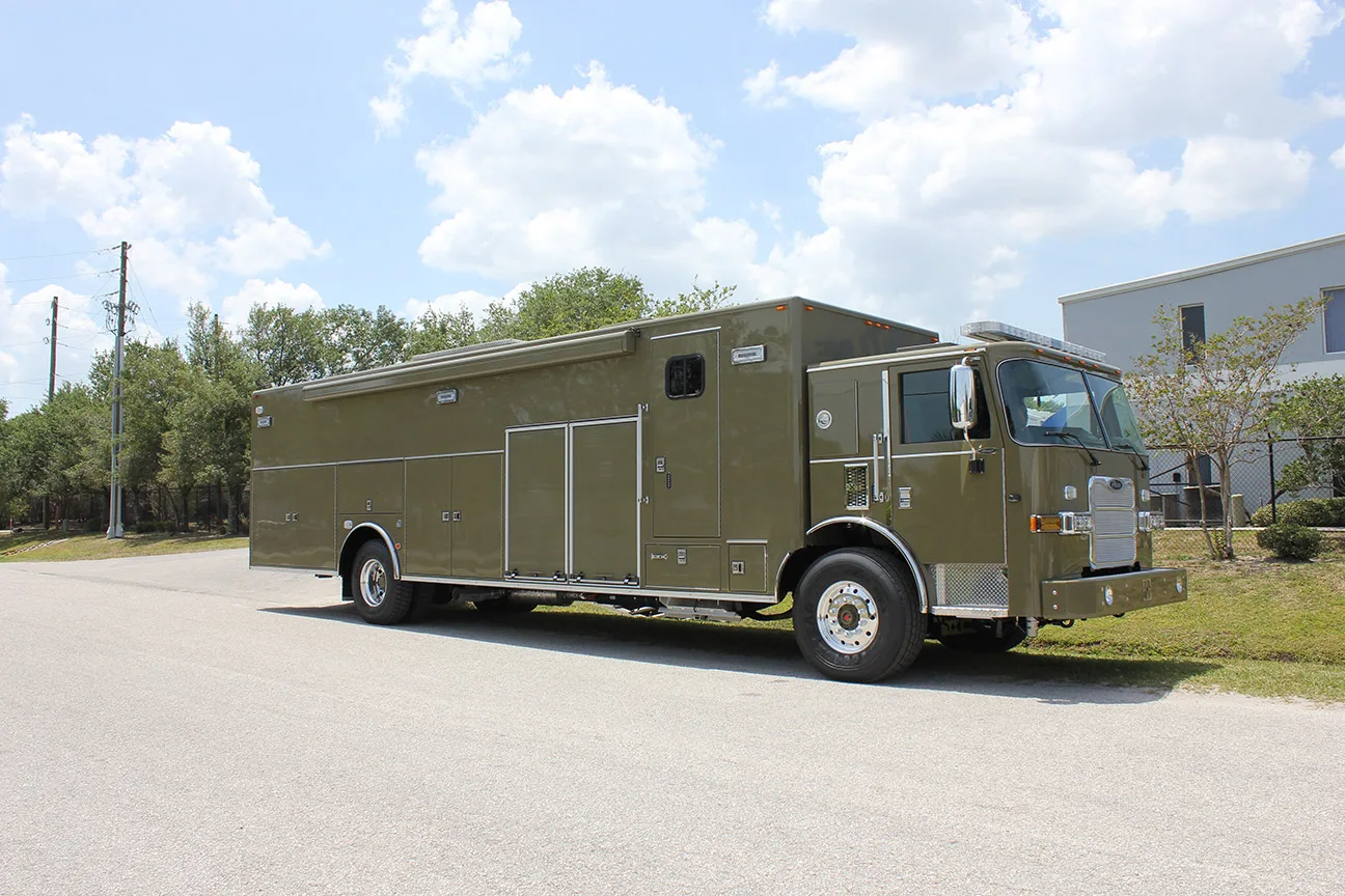 C-40 SWAT vehicle parked outside near the Frontline Communications building on a sunny day.
