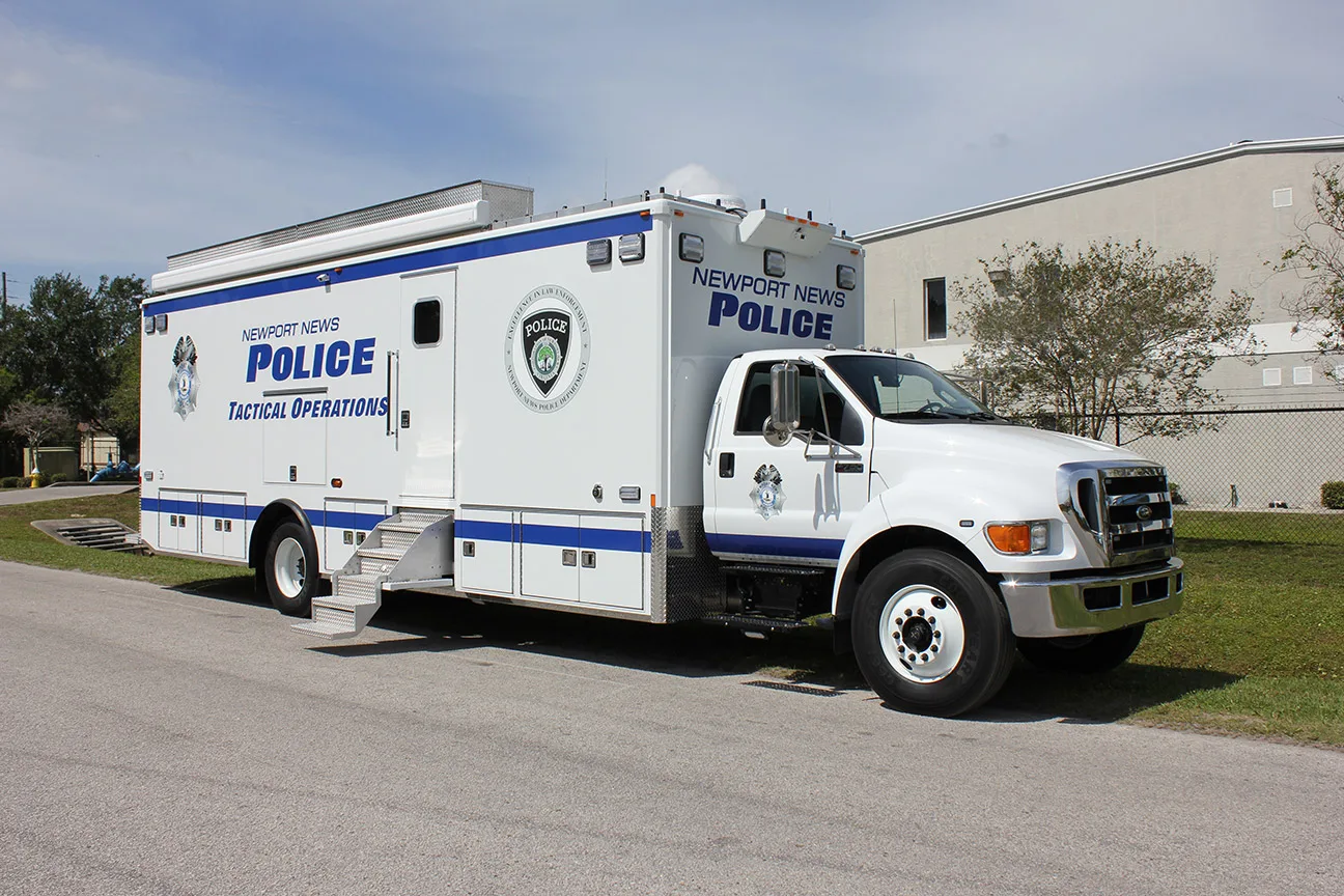 C-40 SWAT vehicle parked outside near the Frontline Communications building on a cloudy day.