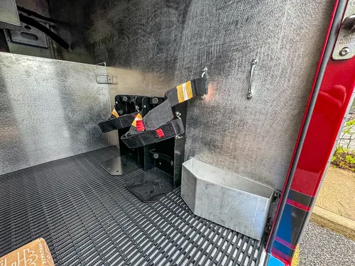 Compartment floor close-up with mounting brackets and fixtures.