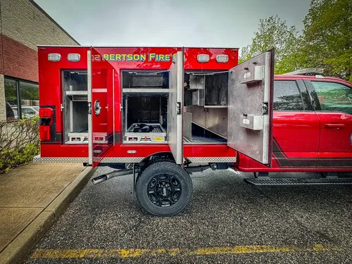 Wide rear side view with multiple compartments open.