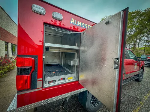 Open side compartment with shallow shelf and storage bin.