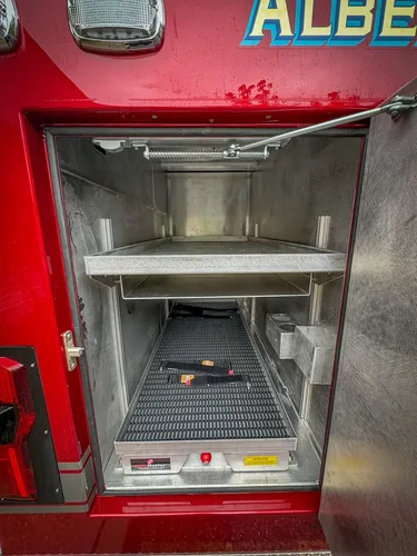 Deep compartment interior with upper shelf and floor tray.