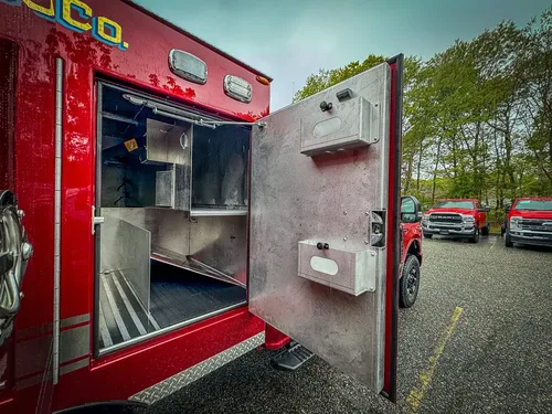 Open compartment with shelf and side-mounted outlet module.