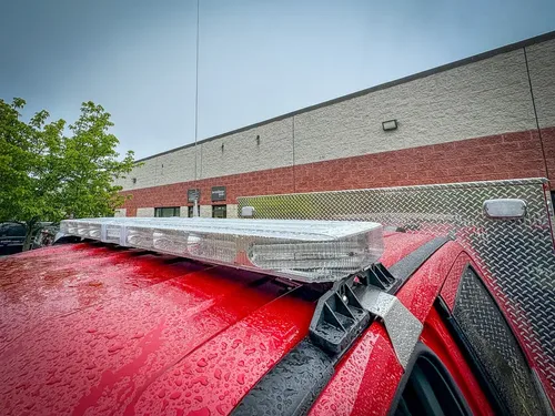 Roof-mounted light bar on top of cab from rear angle.