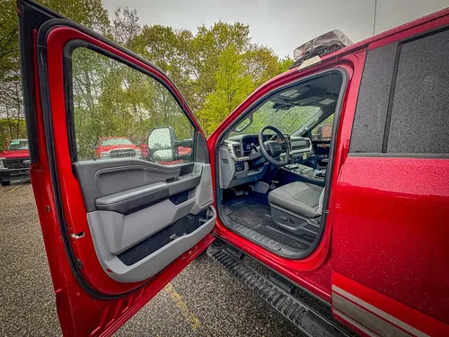 Open front passenger door showing cabin entry and seat.