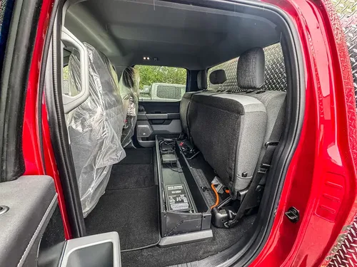 Rear cabin floor area and equipment track behind front seats.