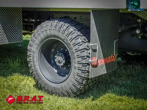 Rear tire close-up with mudflap and utility body edge.