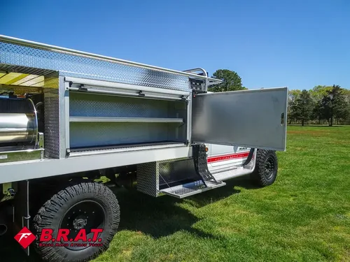 Passenger-side rear compartment open with long shelf tray.