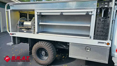 Passenger-side compartment bay open with shelf storage.