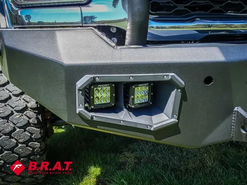 Front bumper auxiliary light pod close-up on textured mount.