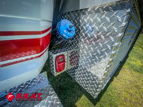 Rear side corner with blue utility cap and taillight.