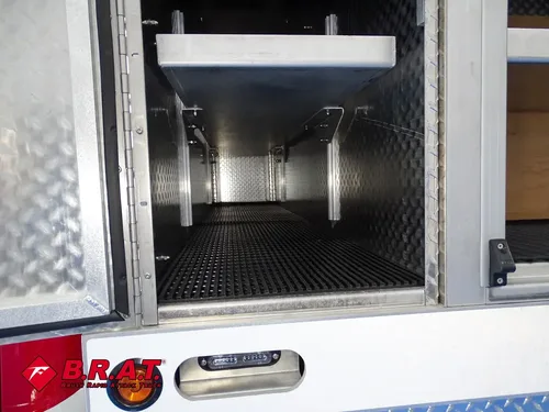 Open vertical compartment with center shelf and interior lighting.