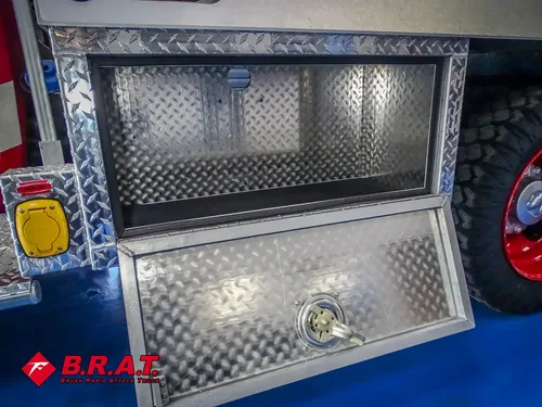 Open lower side compartment with diamond-plate door and latch.
