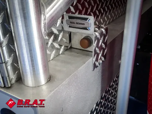 Close-up of polished vertical exhaust stack next to body panel.