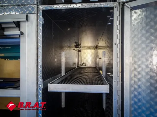 Tall open compartment with shelf and black mat floor.