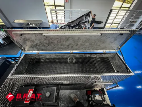 Raised lid over top storage box on rear deck.