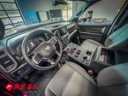 Driver-side cabin view showing steering wheel, dash, and center console.
