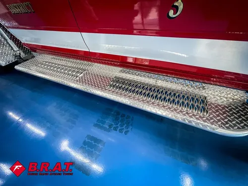 Long diamond-plate running board below passenger door.