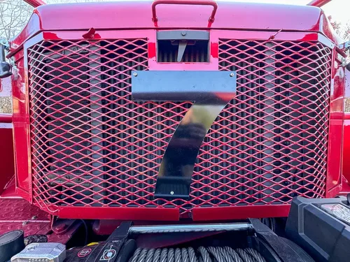 Front grille mesh close-up with large number seven emblem.