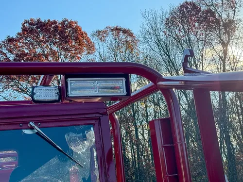 Top windshield rail close-up with center warning light module.