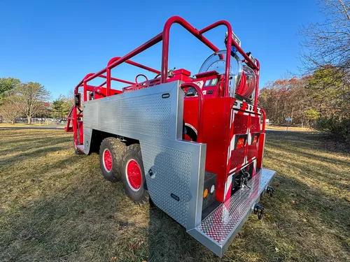 Rear-right three-quarter view with side rail framework and rear step.