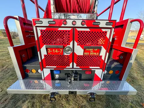 Straight rear view with mesh doors and platform step.