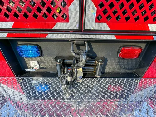 Rear bumper corner close-up with hitch and taillight housing.