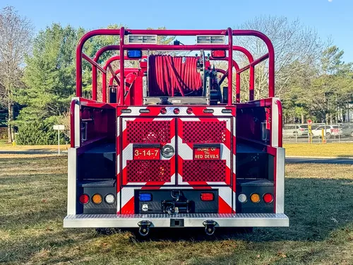 Straight rear view with chevron panel and hose reel at top.