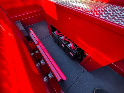 Top-side compartment with mounted electrical components along one side.