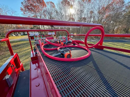 Top deck floor view with hose loops and rail guards.