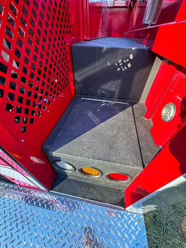 Small rear-side cubby with mesh panel and empty interior.