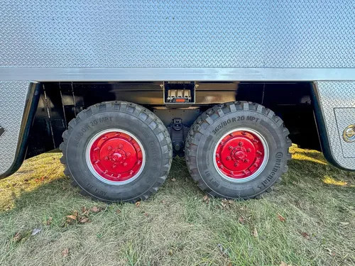 Tandem rear wheel close-up beneath the side body.