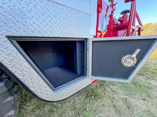 Open lower side compartment door with empty interior space.