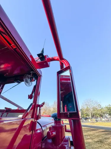 Underside mirror or camera mount close-up near upper rail.