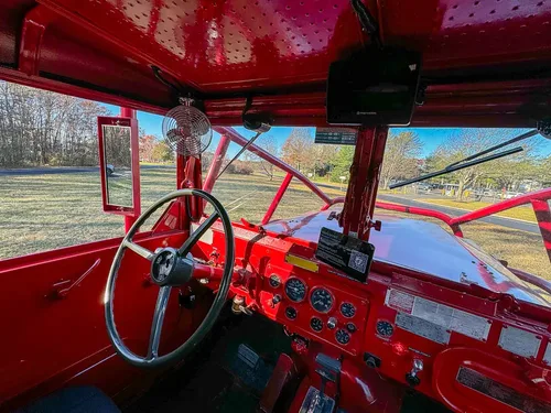 Wide cab interior showing dual controls and front dashboard.