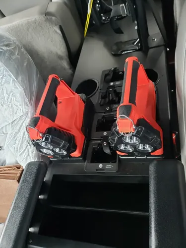Exterior view of small fire truck showing cab, body compartments, and wheel/tire area.