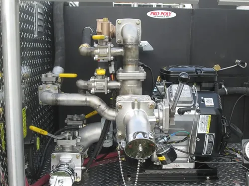 Exterior view of small fire truck showing cab, body compartments, and wheel/tire area.