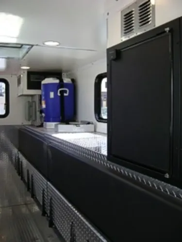 Passenger-side front angle with department door emblem visible.