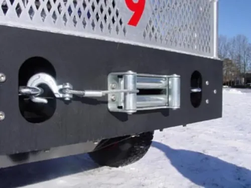 Exterior view of small fire truck showing cab, body compartments, and wheel/tire area.