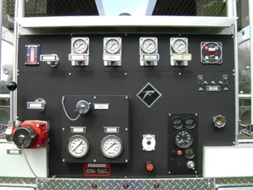 Exterior view of small fire truck showing cab, body compartments, and wheel/tire area.