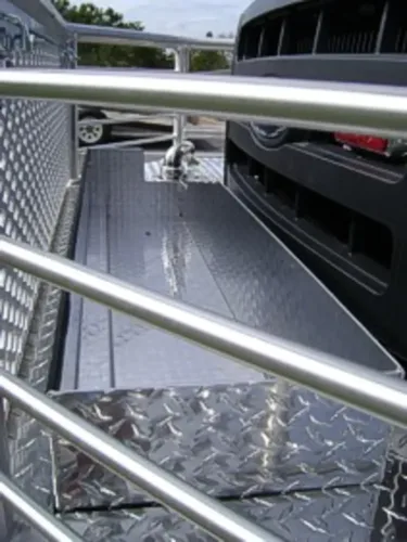 Exterior view of small fire truck showing cab, body compartments, and wheel/tire area.