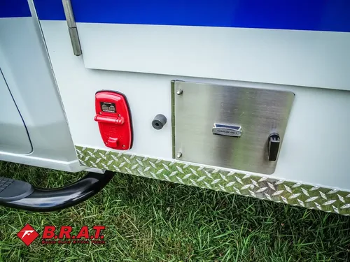 Lower side panel with taillight and closed utility hatch.