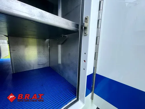Compartment interior side shelf and blue floor corner.