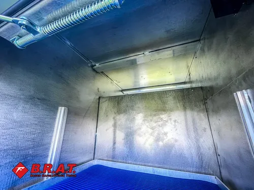 Compartment interior close-up with smooth stainless walls.