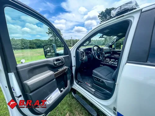Open driver door showing cab entry and dashboard.