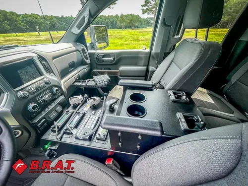 Front seats and center console with mounted control equipment.